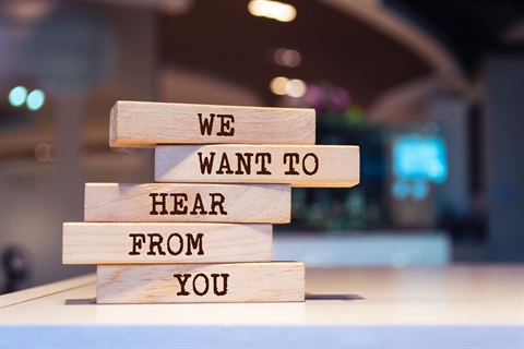 Stack of jenga blocks that say We Want Your Feedback